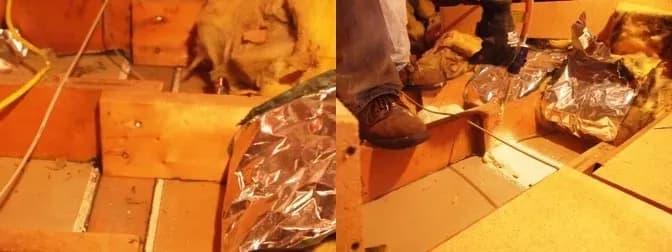 Attic view with exposed wooden beams and foil-wrapped insulation. A person wearing brown boots steps cautiously near the beams. Warm lighting.