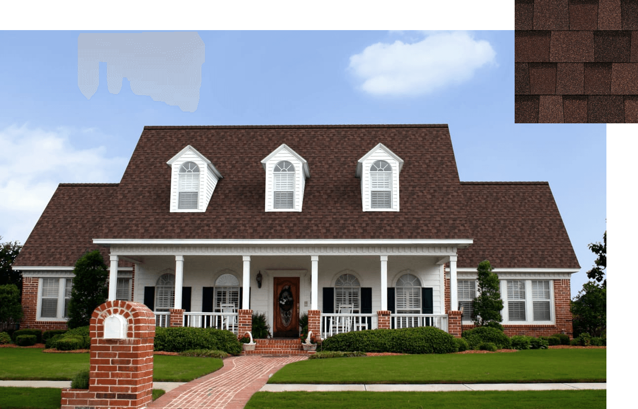 Spacious, traditional house with brown shingles, a large porch, white columns, and manicured lawn under a clear blue sky. Classic and welcoming.